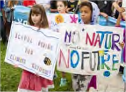 Young children at a climate march holding placards: children speaking up about the future they will inherit.