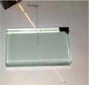 A ray of light reaching the face of a glass slab, with the normal drawn on the paper where the ray enters.