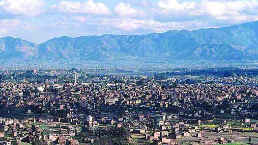 Kathmandu spreads across its valley, ringed by green hills.