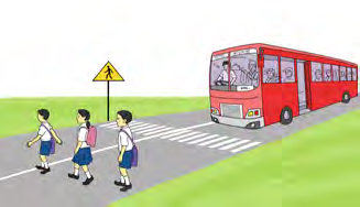 Children crossing the road at the zebra crossing while the bus waits. Crossing at the marked place is right.