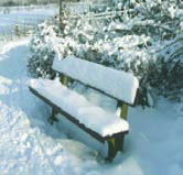 A bench buried under snow: snowy weather.